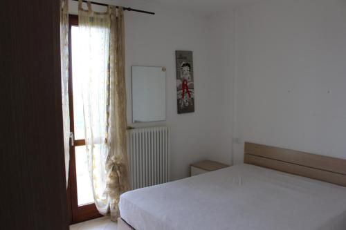 Posteľ alebo postele v izbe v ubytovaní Appartamento Metaurilia