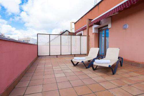 two chairs on the balcony of a building at Agora Juan de Austria in Madrid