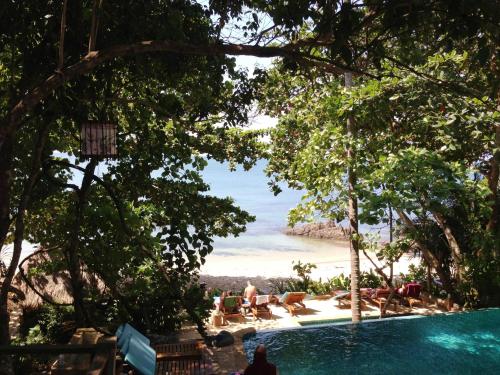 a swimming pool with a view of the beach at The Narima - SHA Plus in Ko Lanta