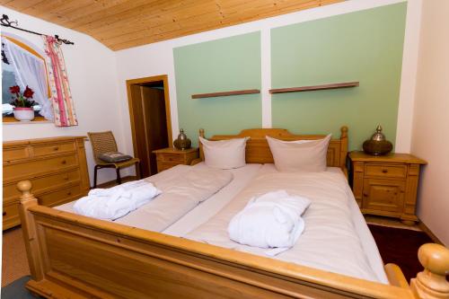 a bedroom with a large bed with white pillows at DEVA Hotel Kaiserblick in Reit im Winkl