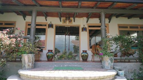 a house with a fountain in the middle of it at Villa Mimi in Otavalo