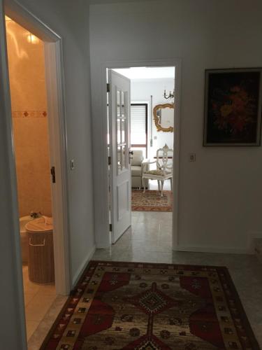 a hallway with a door leading to a living room at Casa do gato branco in Furadouro