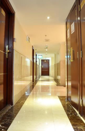 a hallway of a building with glass doors and a hallwayngth at Saffron Hotel in Dubai