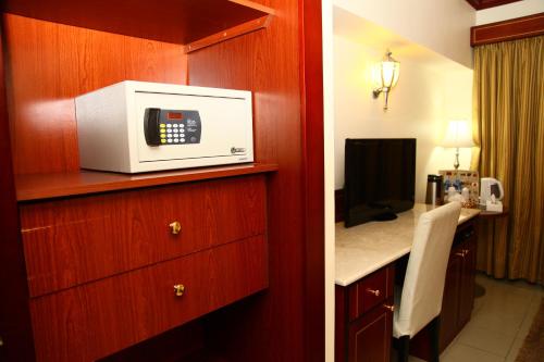 a hotel room with a kitchen with a microwave at Saffron Hotel in Dubai