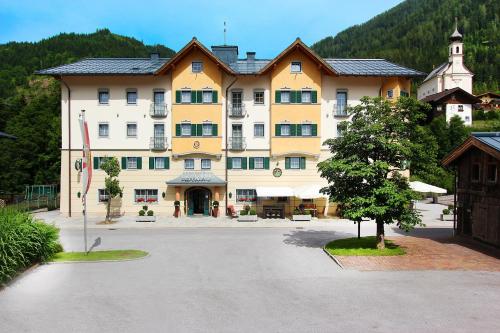 a large building in the middle of a street at Familienresort Reslwirt in Flachau