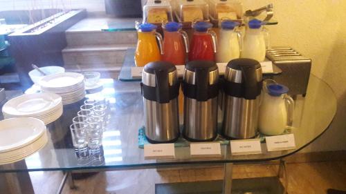 a glass table with a group of kettles on it at Best Western Maryland in Chandīgarh
