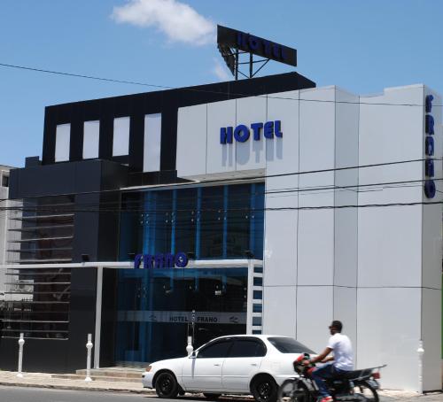 a man riding a motorcycle in front of a hotel at Hotel Frano Romana Center in La Romana
