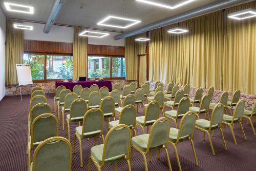 a room with rows of chairs and a podium at Amalia Hotel Delphi in Delfoi