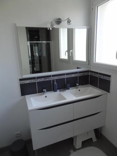 a bathroom with a white sink and a mirror at Gîte du Château d'Eau in Fécamp