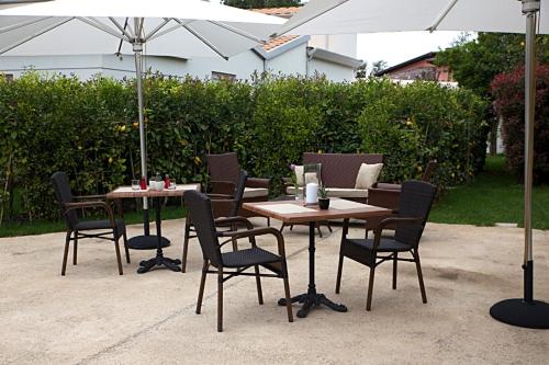 a table and chairs with an umbrella on a patio at Don Antonino Relais in Sorrento