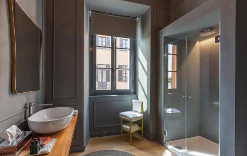a bathroom with a sink and a shower at Suites Menaggio in Menaggio