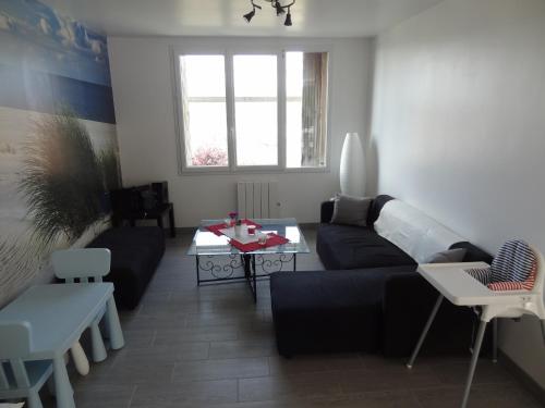 a living room with a couch and a table at Gîte du Château d'Eau in Fécamp