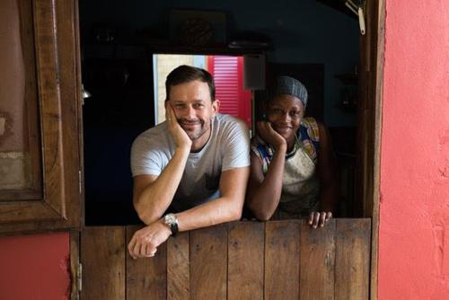a man and a woman looking over a wooden fence at Evergreen Eco Lodge Retreat in Tujering