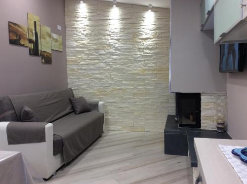 a living room with a couch and a fireplace at Tramonti di Sole in Tramonti