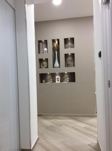 a room with a vase on a wall with shelves at Tramonti di Sole in Tramonti