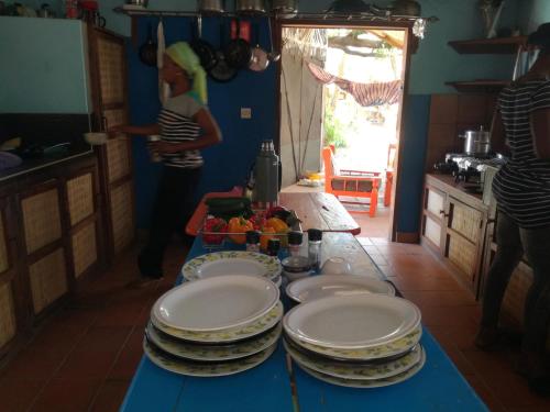 a table with plates on it in a kitchen at Evergreen Eco Lodge Retreat in Tujering