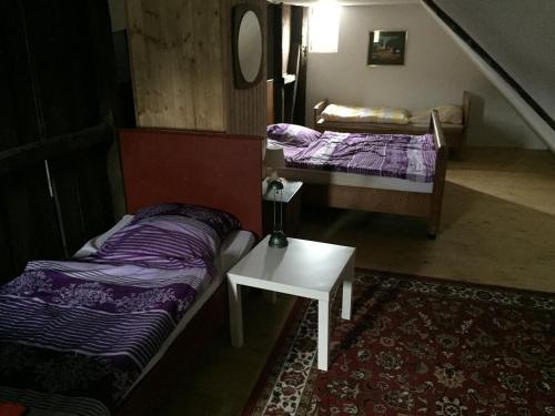 a room with two beds and a table in it at Biogut Evensen in Evensen
