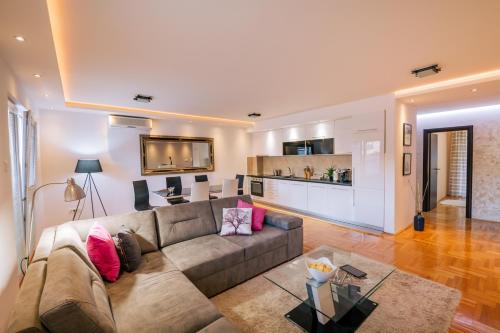 a living room with a couch and a table at Apartments Danigo in Budva