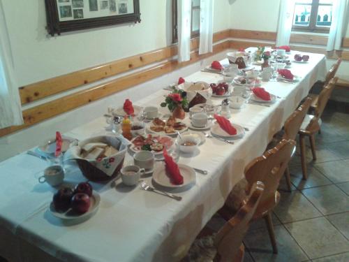 a long table with plates of food on it at Tourist Farm Pri Martinovih in Krška Vas