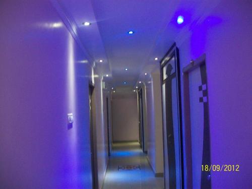 a hallway with purple lights in a building at Hotel Viraat Inn in Gaya