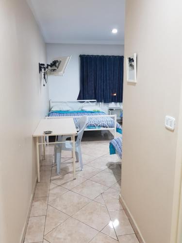 a room with a table and a bed and a window at Hotel Afef in Tunis