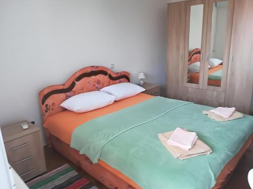 a bedroom with a bed with two towels on it at Apartments Vukovic in Sveti Stefan