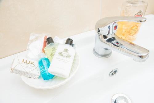 a bathroom sink with toothbrushes and toothpaste on it at Linsfort Guest House in Boyle