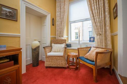 a living room with two chairs and a window at Linsfort Guest House in Boyle