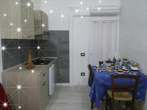 a kitchen with a table with a blue table cloth at B&B da Bibi in Fabriano