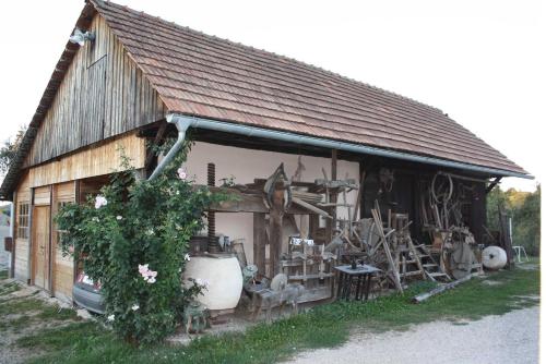a building with a lot of old items on it at Tourist Farm Pri Martinovih in Krška Vas