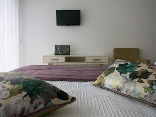 a bedroom with a bed and a tv on the wall at Hotel Rural da Freita in Arouca