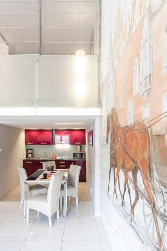 a dining room with a horse mural on the wall at Wroclaw Inn Apartments in Wrocław