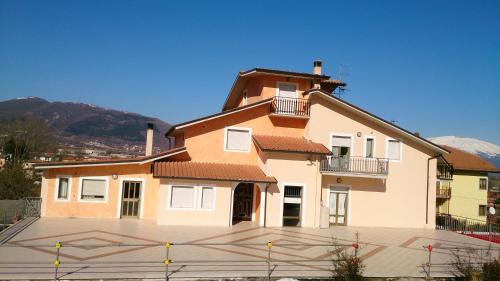 a large house with a balcony on top of it at Hotel Grazia Ristorante in LʼAquila