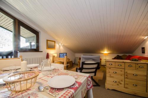 a room with a table and chairs and a dresser at Petra in Chamonix