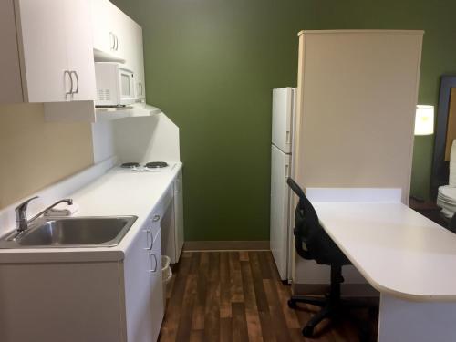 a small kitchen with a sink and a refrigerator at Extended Stay America Suites - Chicago - Gurnee in Gurnee