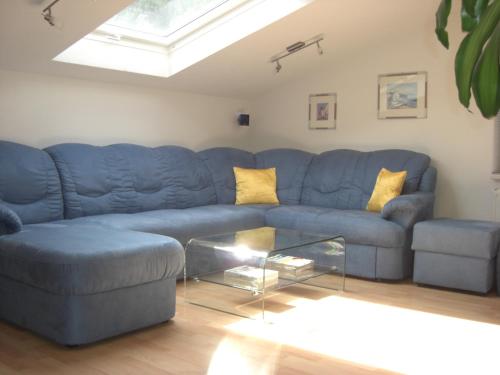 a blue couch with yellow pillows in a living room at Appartments Stefania in Tösens