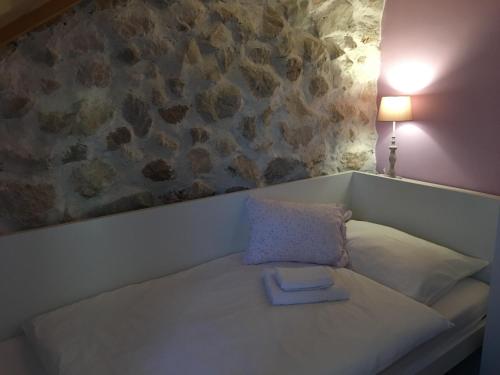 a white couch with a blue book on it at Holiday Home Cvita in Lozovac