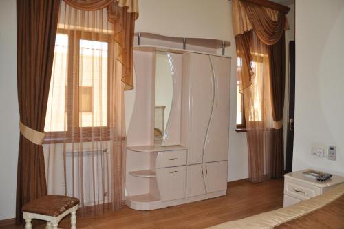 a white dresser with a mirror in a room at Armenia VanSevan Hotel in Sevan