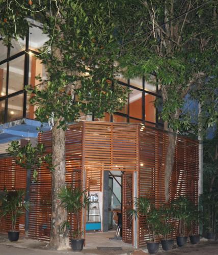 a building with a tree in front of it at Cinnamon Airport Residencies in Katunayaka