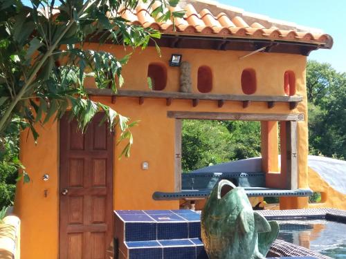 a play house with a fish statue in front of it at Reef View Pavilions - Villas & Condos in Lance aux Épines