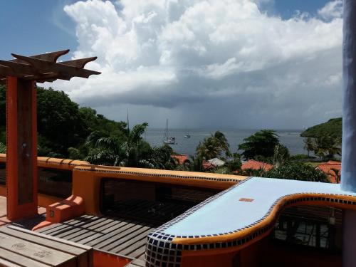 a view of the ocean from the balcony of a house at Reef View Pavilions - Villas & Condos in Lance aux Épines