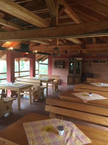 a large room with wooden tables and benches at Kod Dace in Banja Topilo