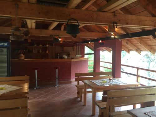 a restaurant with wooden tables and benches in a room at Kod Dace in Banja Topilo