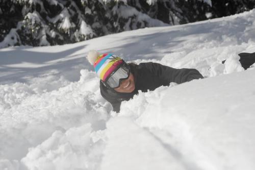 a man is laying in the snow at Villa Edelweiss in Alleghe