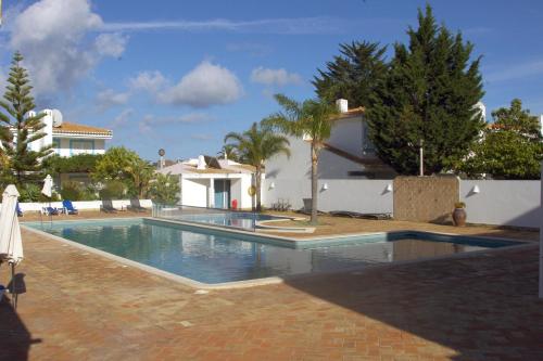 a swimming pool in front of a house at Casa JaRoCa in Lagos