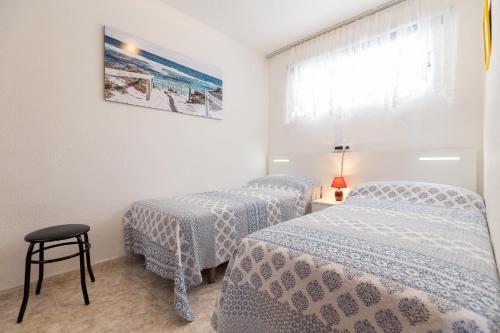 two twin beds in a room with a window at Sky park in Benidorm