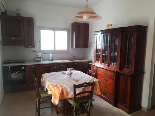 ピッツォルンゴにあるA Due Passi Dal Mareのキッチン(テーブル、キャビネット、窓付)