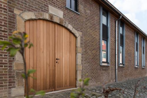 a wooden garage door on a brick building at Constantinus in Herzele
