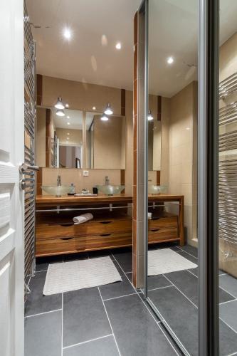 une salle de bain avec deux lavabos et deux miroirs dans l'établissement PREF 2 · F4 - VASTE ET BOURGEOIS ,3 CHAMBRES, ASCENSEUR, VX-NICE, à Nice