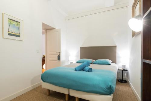 une chambre avec un grand lit avec des oreillers bleus dans l'établissement PREF 2 · F4 - VASTE ET BOURGEOIS ,3 CHAMBRES, ASCENSEUR, VX-NICE, à Nice